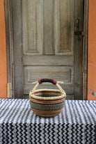 Small round shopping basket, a handwoven Bolga basket in tough elephant grass.