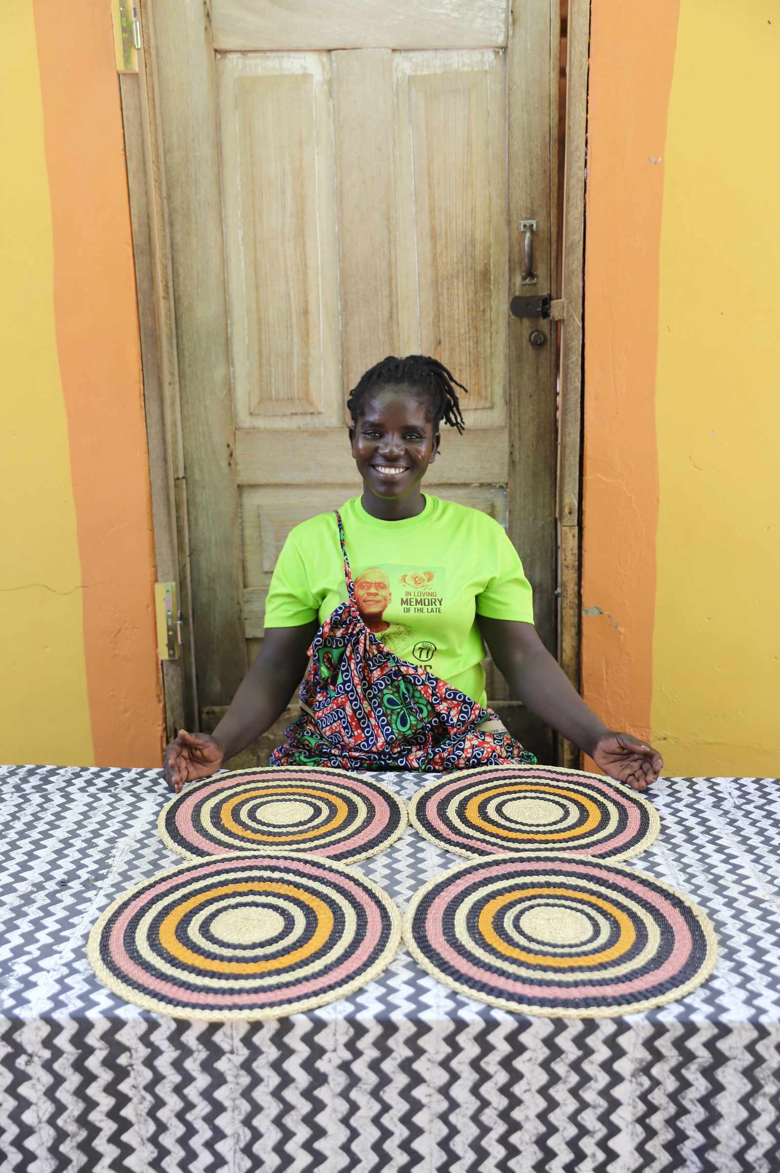 Set of four handwoven Bolga placemats in natural straw with concentric ring pattern, displayed in Bolgatanga, Ghana.
