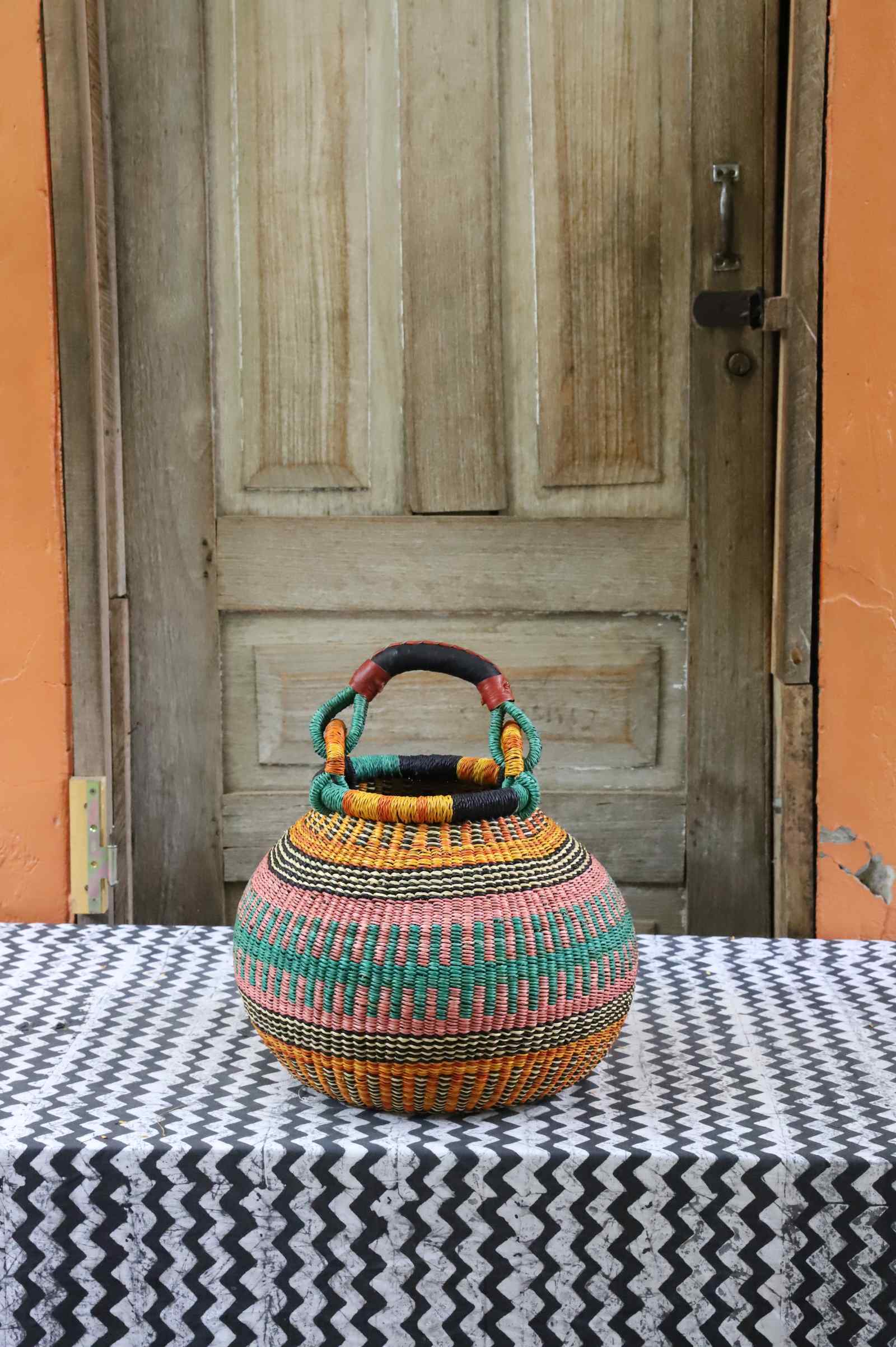 Pot storage basket in elephant grass, a handwoven Bolga basket with a narrowed neck.