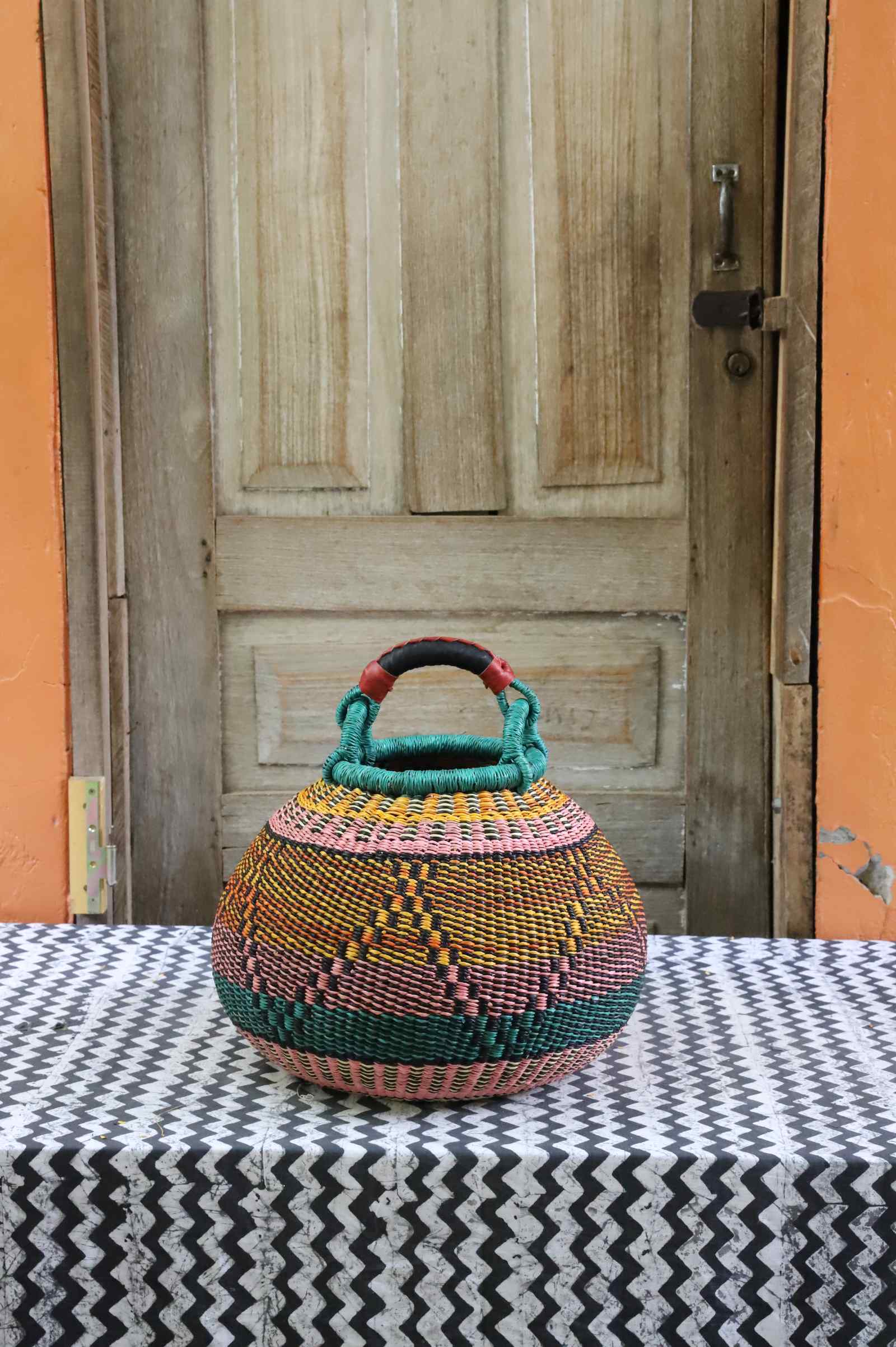 Pot storage basket, a handwoven Bolga basket in elephant grass with a rounded pot form.