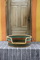 Small woven dog bed handwoven from elephant grass in Bolgatanga, Ghana.