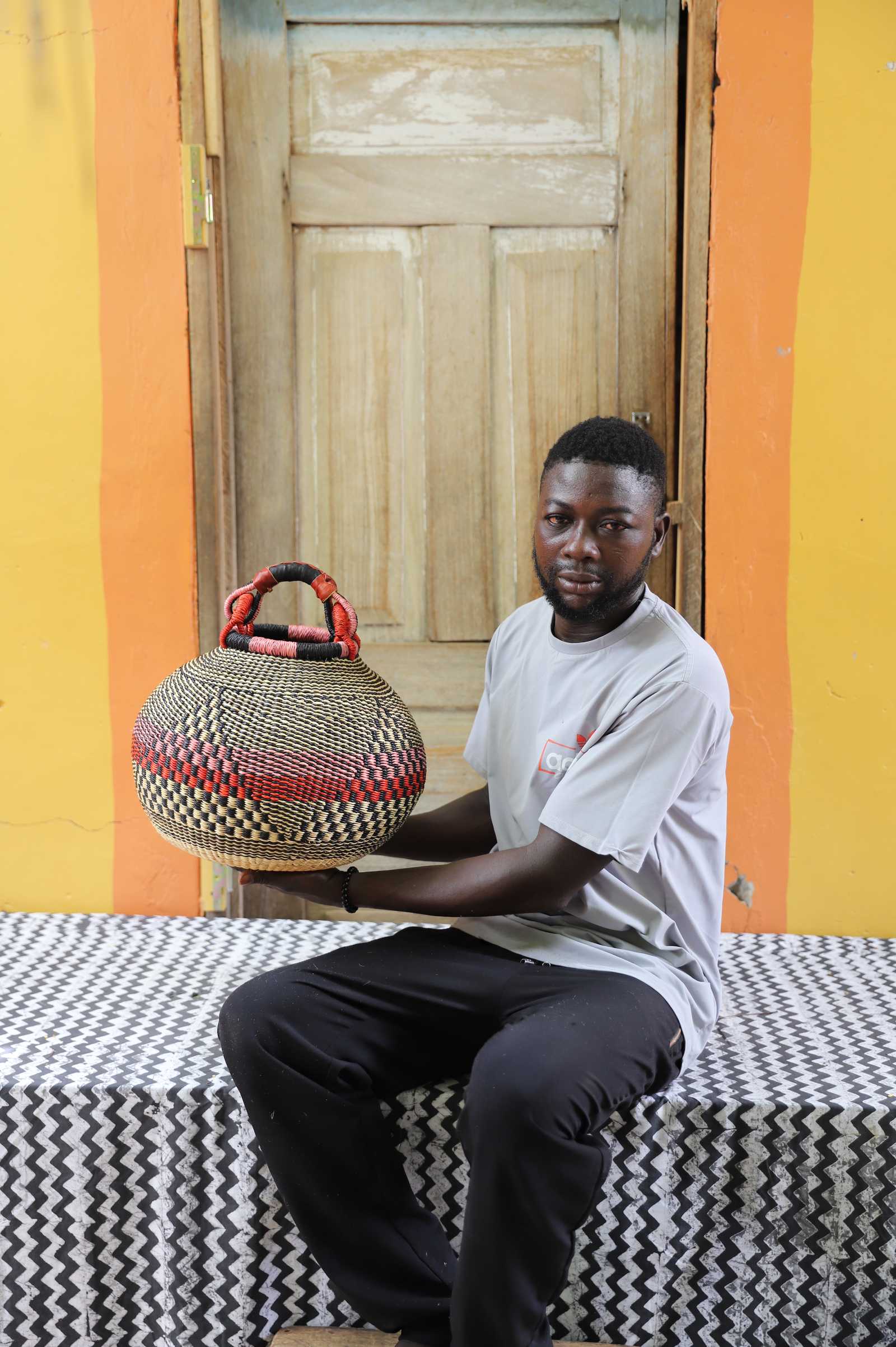 Rounded pot storage basket handwoven in elephant grass, equal parts sculpture and storage.