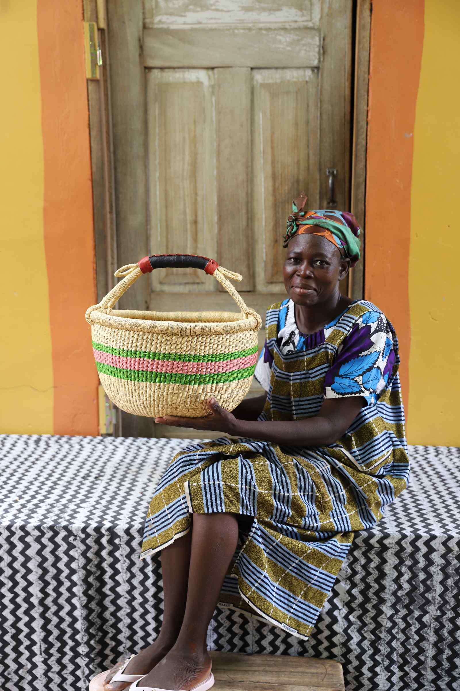 Medium handwoven African basket in elephant grass, 38 cm wide with twin handles.