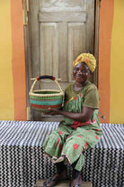 Small round woven basket in elephant grass, 33 cm across, made for everyday carrying.
