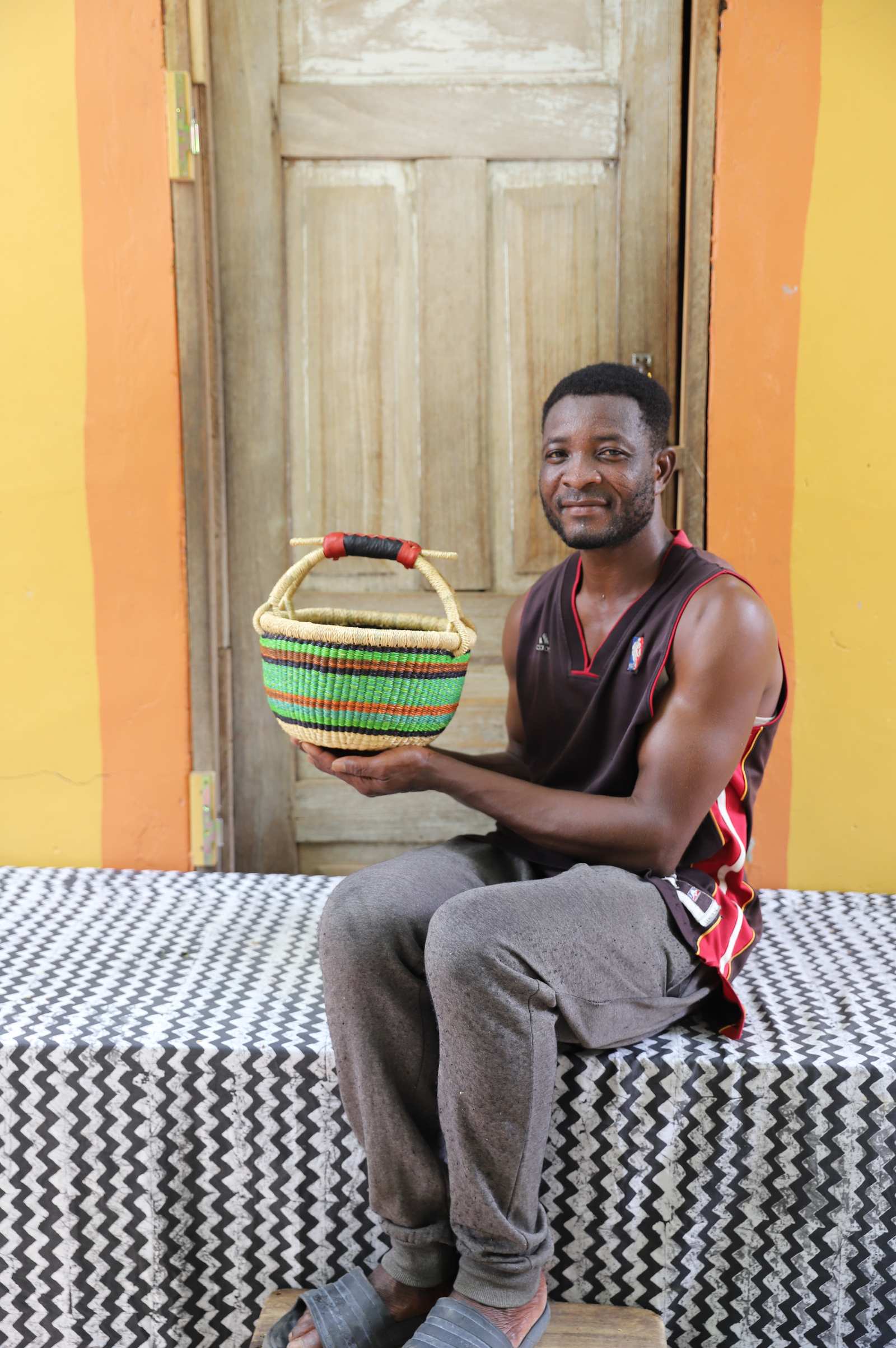 Small handwoven African basket in elephant grass, 30 cm wide and 17 cm tall.