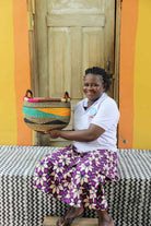Open handwoven Bolga basket in elephant grass, for fruit, textiles, or keepsakes.