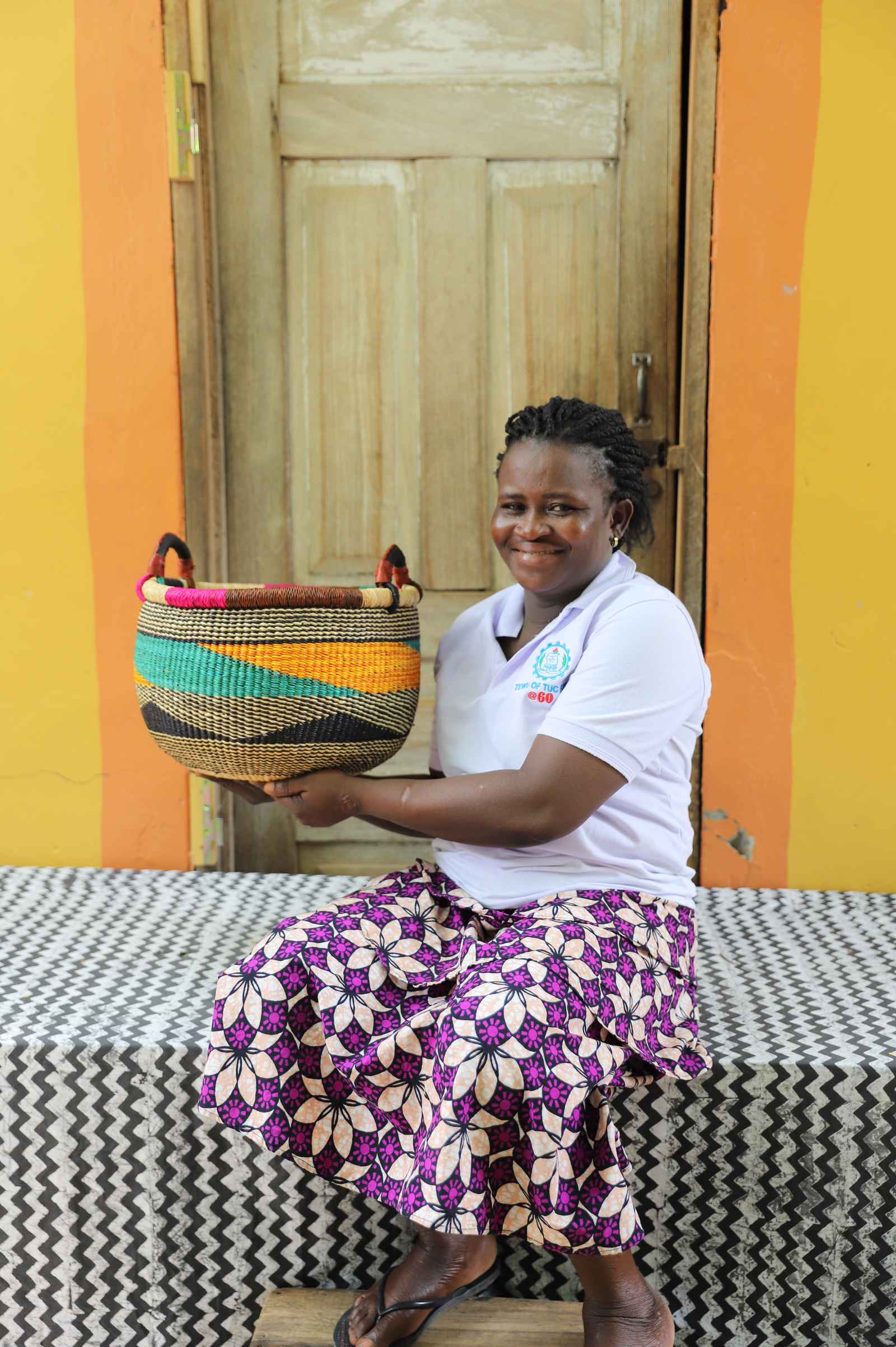 Open handwoven Bolga basket in elephant grass, for fruit, textiles, or keepsakes.