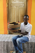 Handwoven African basket in elephant grass, an open storage form 23 cm tall.
