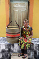 Handwoven Bolga laundry basket in elephant grass, scaled for a living room or nursery.