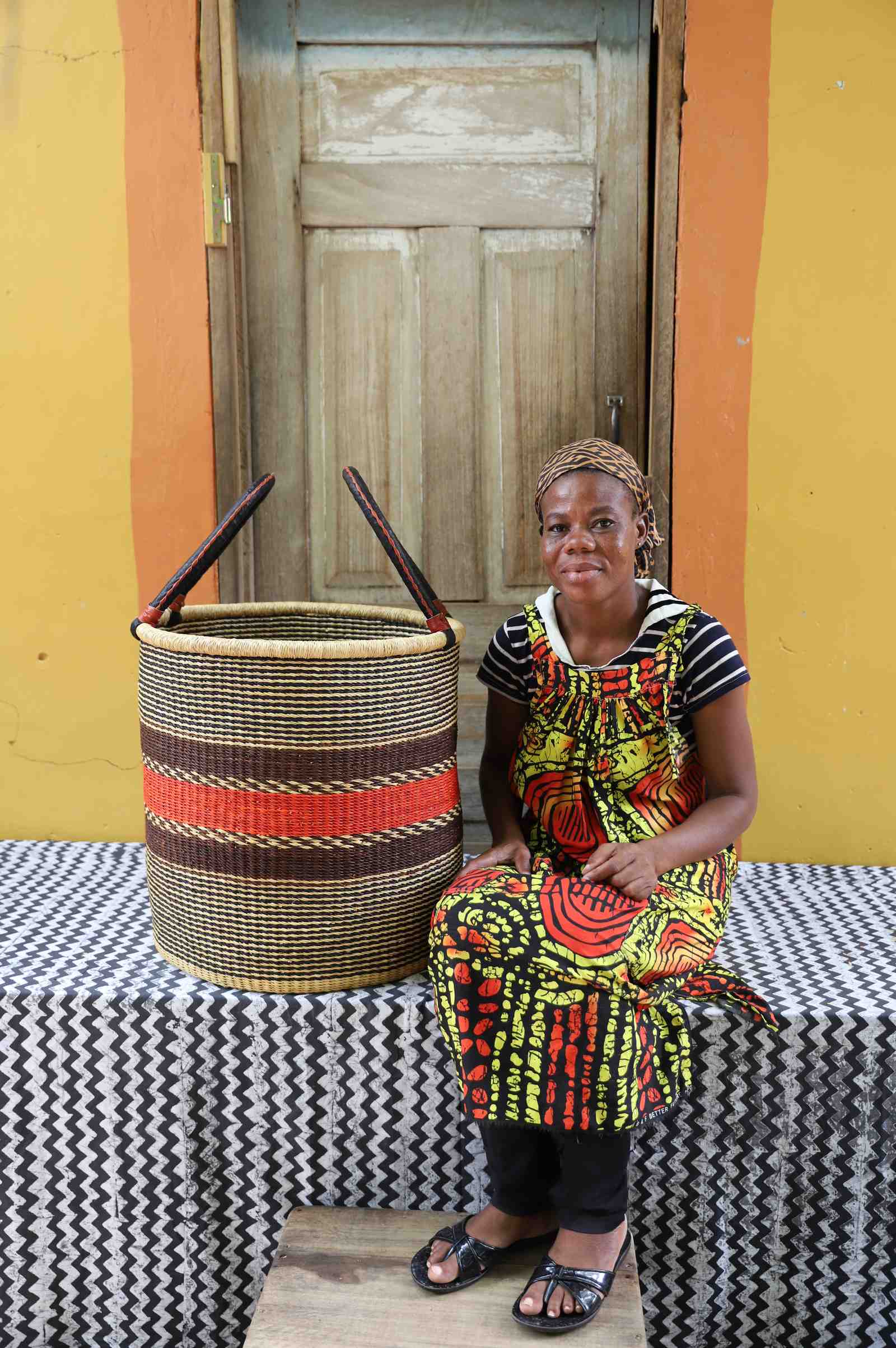 Handwoven Bolga laundry basket in elephant grass, scaled for a living room or nursery.