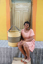 Handwoven Bolga basket with an open top, sized for a bedroom or bathroom.
