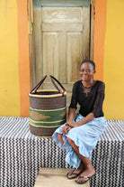 Open laundry basket handwoven in elephant grass, 46 cm tall.